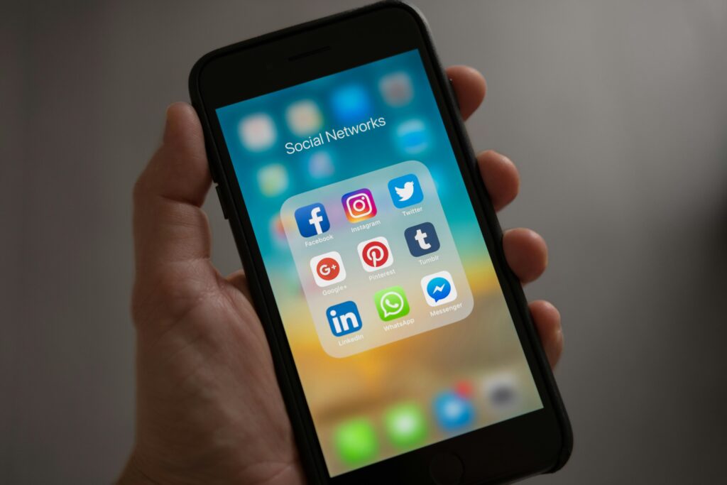 pexels photo 607812 607812 A smartphone displaying various social media icons held in a hand, showcasing modern communication apps.